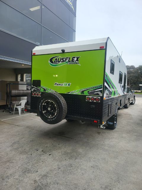 Ausflex Fierce 18.6 in green, rear three-quarter at the factory