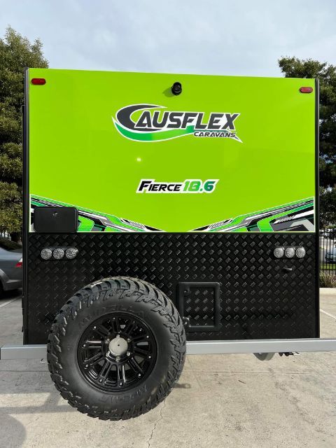 Rear panel of the Ausflex Fierce 18.6 in green, spare wheel mounted on the checkerplate