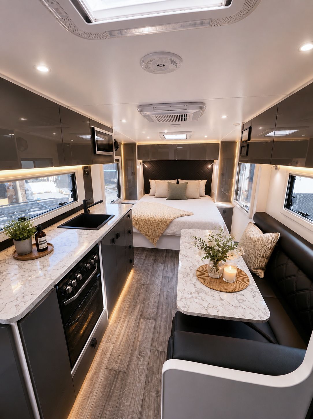 Bedroom at the far end of the van, past the gloss kitchen and marble dinette