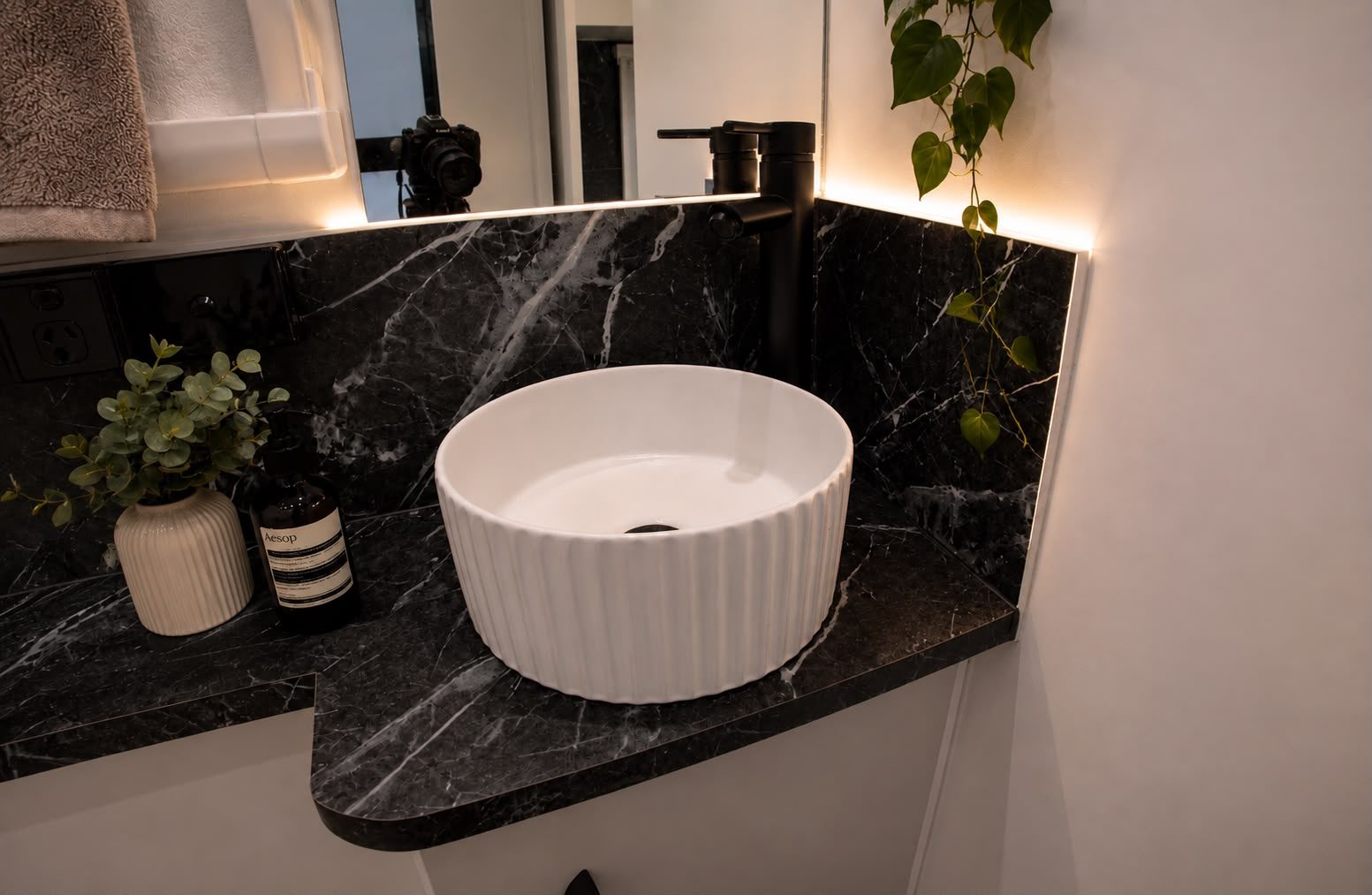 Ensuite vanity with stone benchtop, fluted vessel basin and black tapware